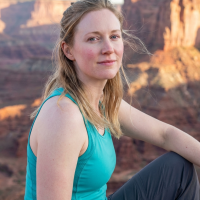 Image of woman sitting in desert canyon